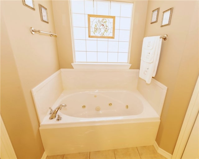 bathroom with tile patterned floors and a tub to relax in