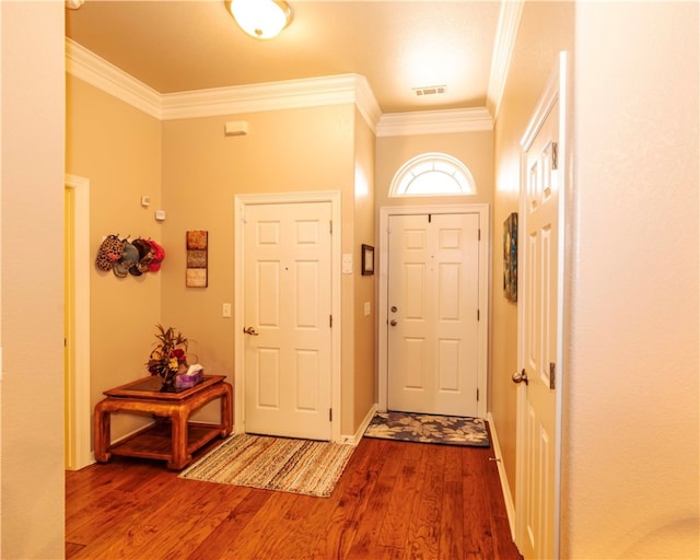 entrance foyer featuring crown molding and hardwood / wood-style floors