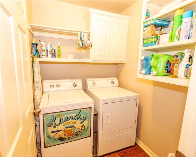 laundry area featuring washing machine and dryer and cabinets