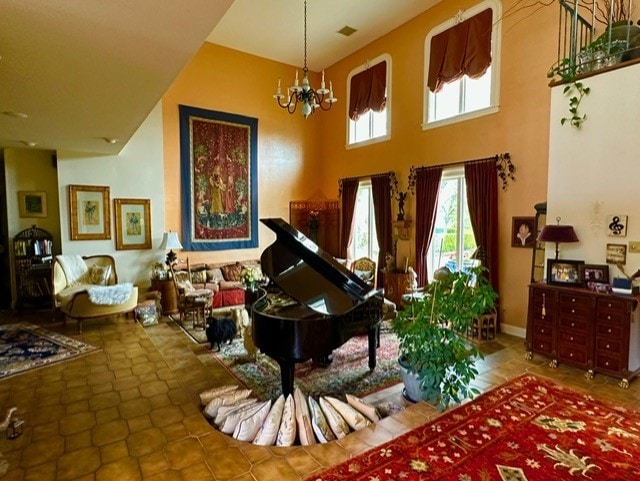 miscellaneous room with a notable chandelier, tile patterned floors, and a high ceiling