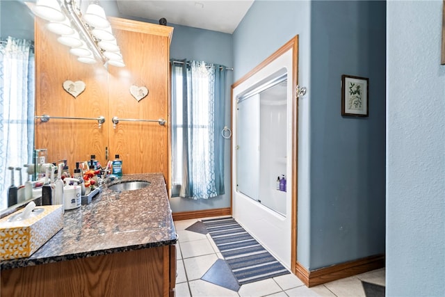 bathroom featuring a wealth of natural light, vanity, shower / tub combination, and tile patterned flooring