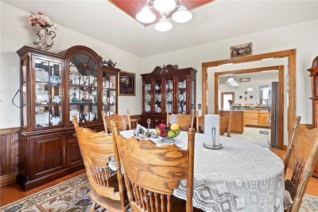 dining room with light hardwood / wood-style floors and a notable chandelier