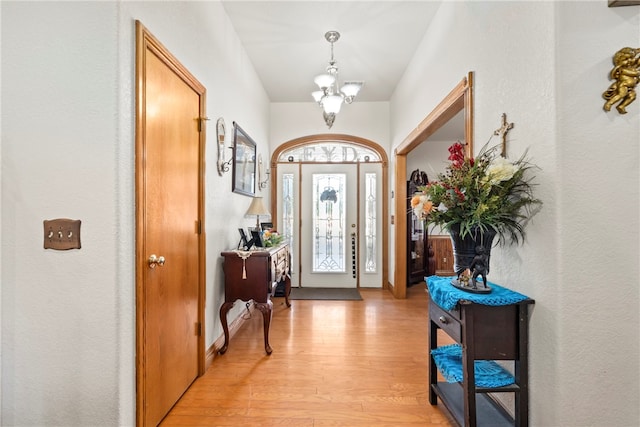 foyer entrance featuring a notable chandelier and light hardwood / wood-style floors