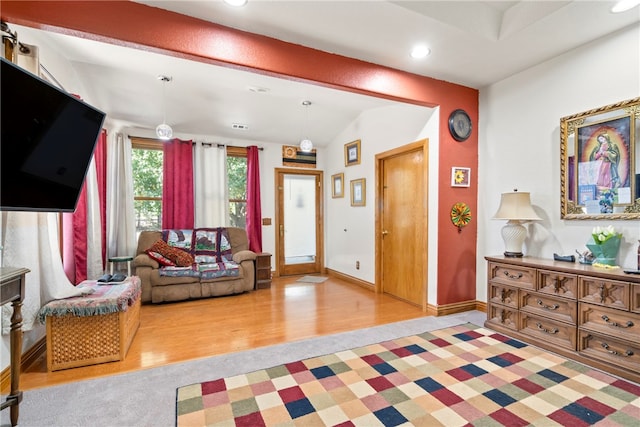 living room featuring vaulted ceiling and light wood-type flooring