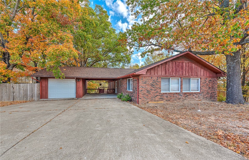 view of front of home featuring a garage and a carport