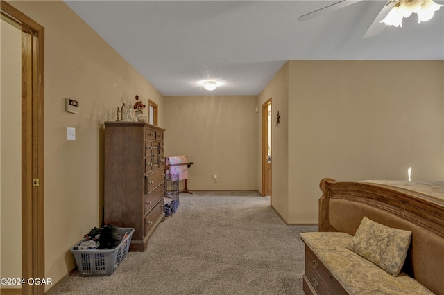 sitting room featuring light colored carpet and ceiling fan