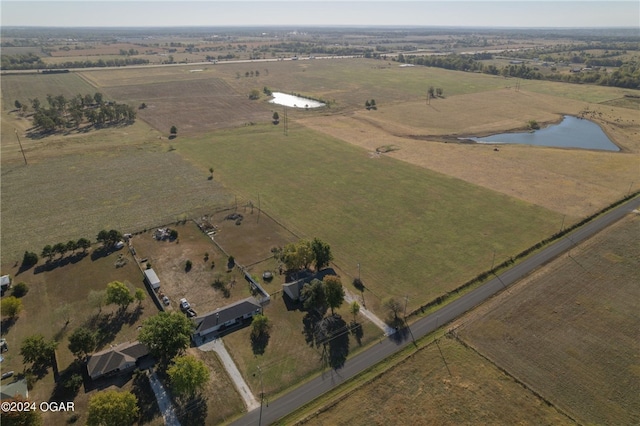 birds eye view of property featuring a water view and a rural view