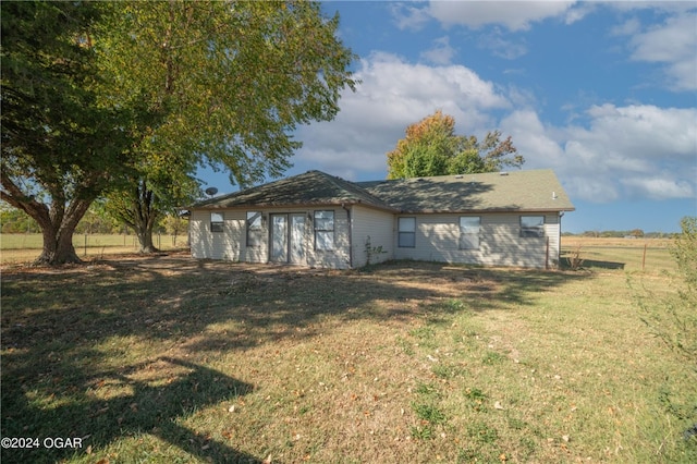 back of property featuring a yard