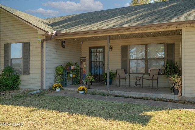 property entrance with a lawn