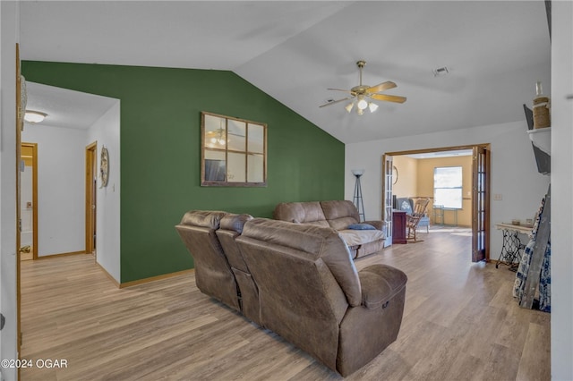 living room featuring lofted ceiling, light hardwood / wood-style flooring, and ceiling fan