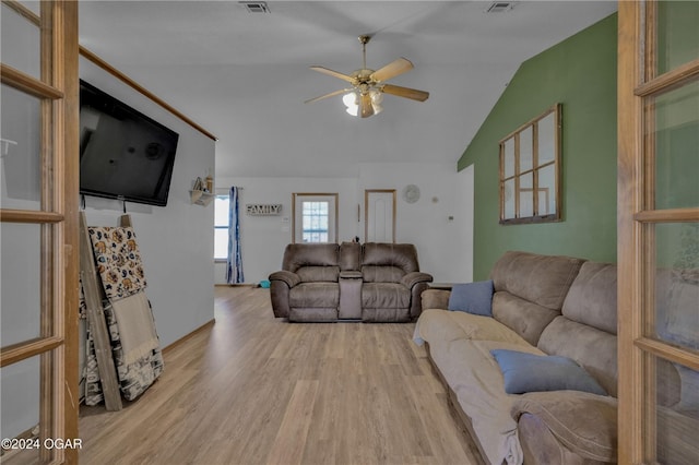 living room with lofted ceiling, light wood-type flooring, and ceiling fan