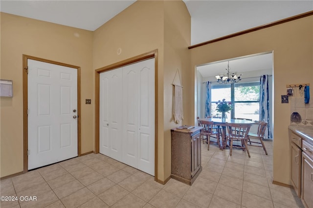 entrance foyer with a chandelier and light tile patterned flooring