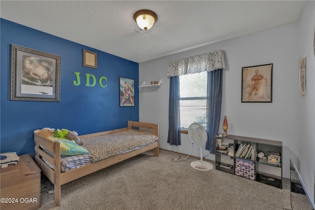 carpeted bedroom with a textured ceiling