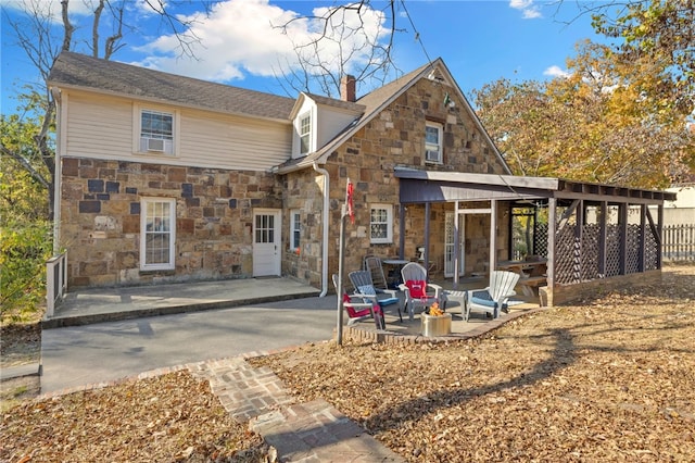 rear view of house featuring cooling unit and a patio area