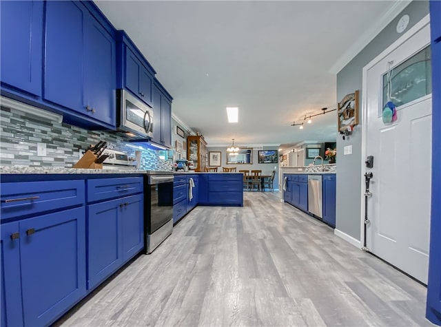 kitchen with backsplash, appliances with stainless steel finishes, light hardwood / wood-style flooring, and blue cabinets