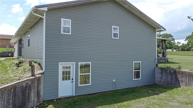 back of house with a lawn