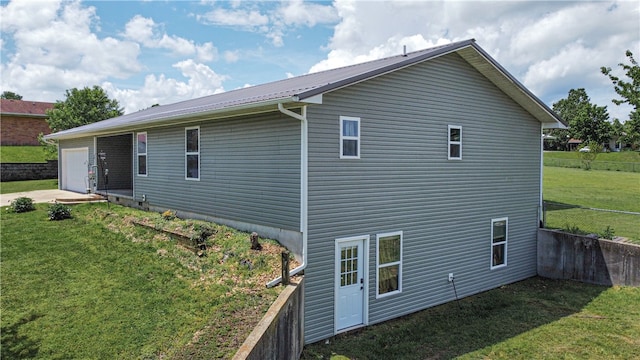 view of property exterior with a patio and a lawn