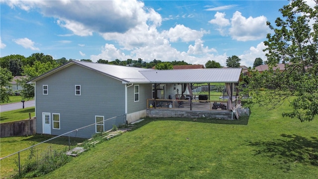 back of property with a patio and a lawn