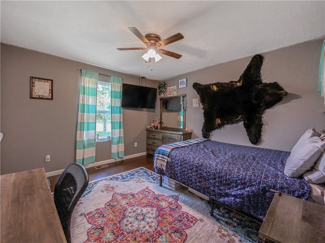 bedroom with ceiling fan and dark hardwood / wood-style floors