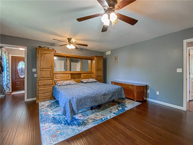 bedroom with dark hardwood / wood-style floors and ceiling fan