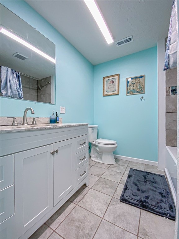 full bathroom with vanity, toilet, tile patterned flooring, and tiled shower / bath