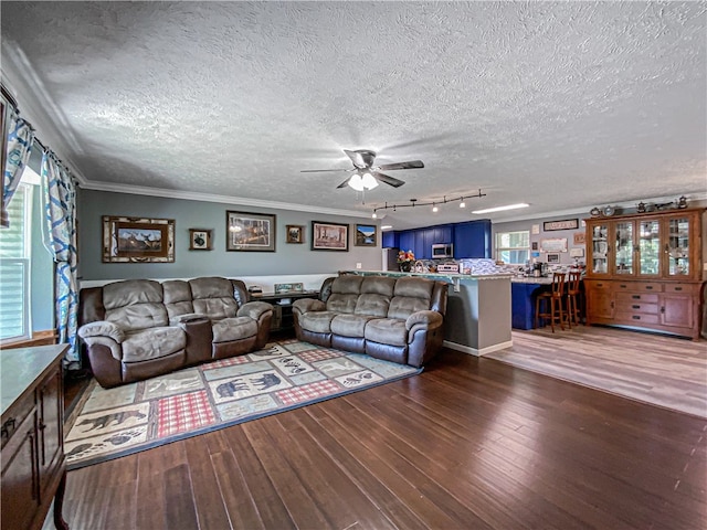 living room with ornamental molding, a textured ceiling, hardwood / wood-style flooring, and ceiling fan