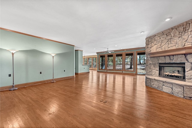 unfurnished living room featuring ceiling fan, a fireplace, and hardwood / wood-style floors