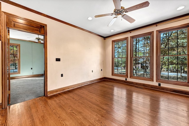 unfurnished room with hardwood / wood-style floors, a healthy amount of sunlight, and ceiling fan