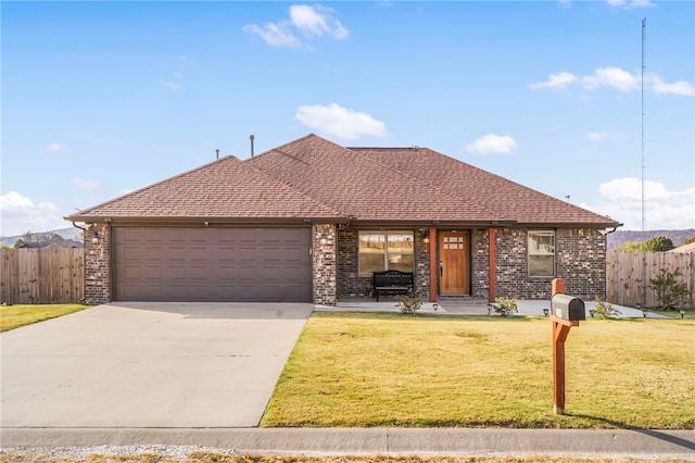 view of front of home with a front yard and a garage