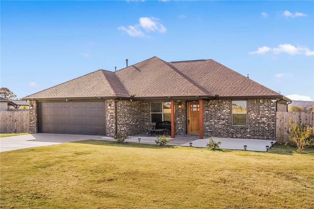 view of front of property with a front yard and a garage