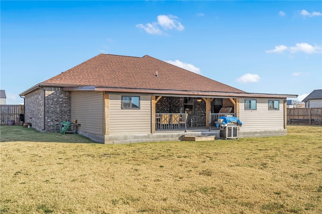 back of property featuring a patio and a lawn