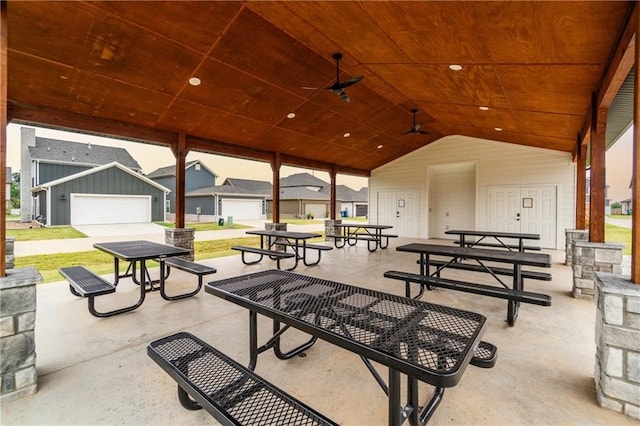 view of patio featuring ceiling fan and a garage