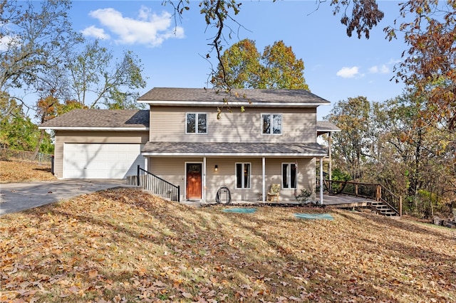 view of property featuring a garage and a front yard