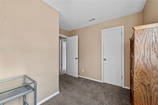 carpeted bedroom with a textured ceiling