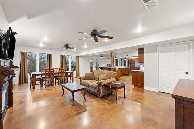 living room with ceiling fan and french doors