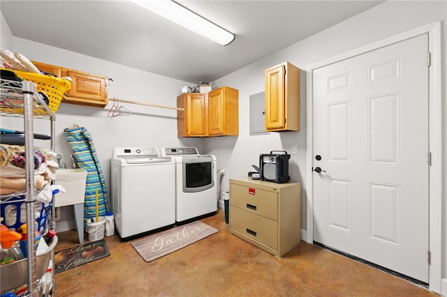 washroom with sink, washer and clothes dryer, and cabinets