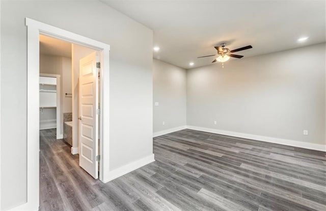 spare room with dark wood-type flooring and ceiling fan