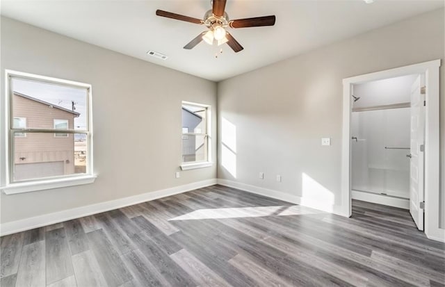 unfurnished bedroom featuring dark wood-type flooring and ceiling fan