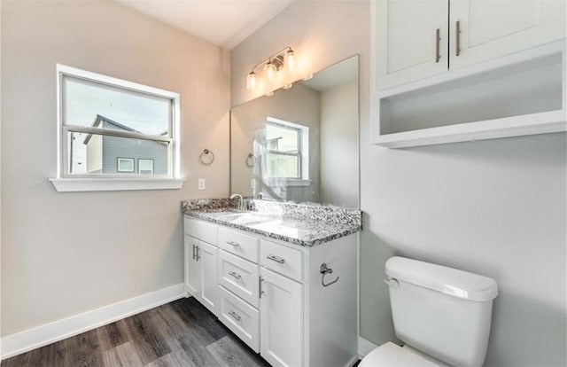 bathroom with vanity, toilet, and hardwood / wood-style flooring