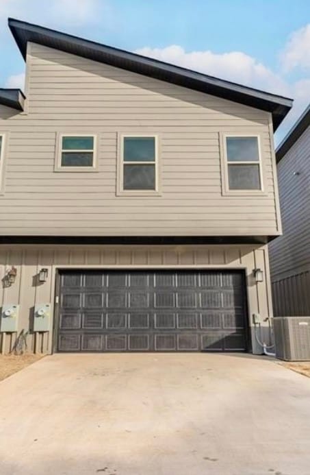 exterior space featuring central AC and a garage