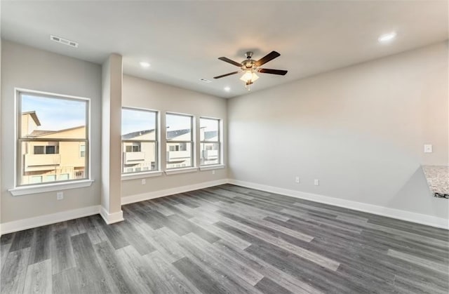 unfurnished room featuring dark hardwood / wood-style floors and ceiling fan