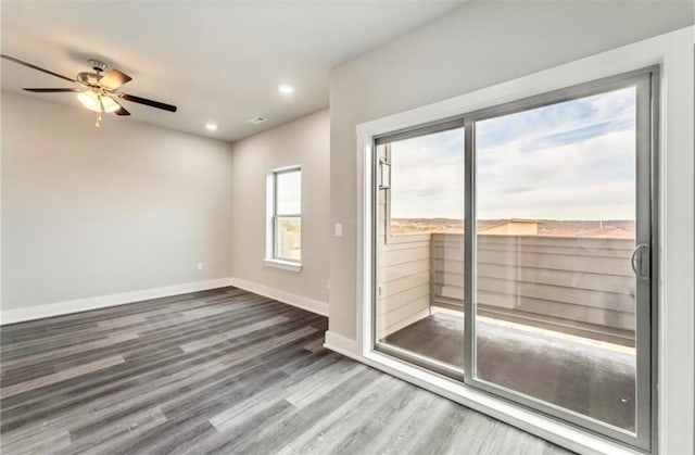 unfurnished room featuring hardwood / wood-style floors and ceiling fan