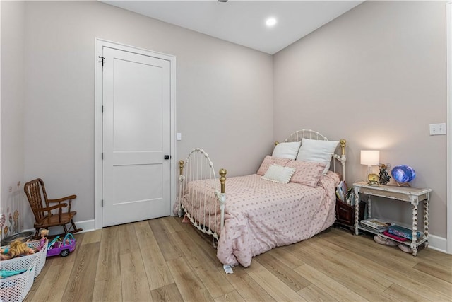 bedroom with recessed lighting, baseboards, and wood finished floors