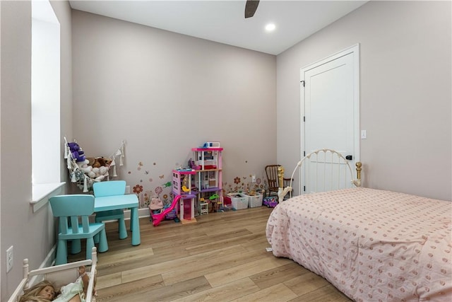 bedroom with ceiling fan, wood finished floors, and recessed lighting