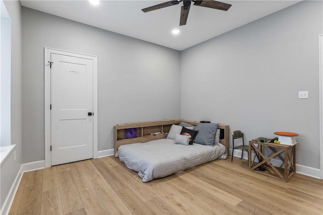 bedroom with recessed lighting, wood finished floors, a ceiling fan, and baseboards