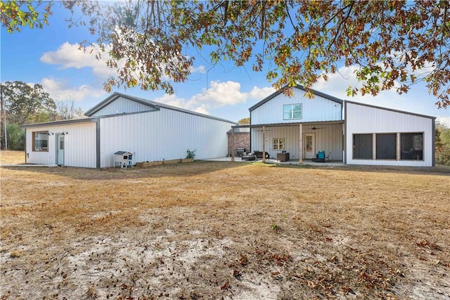 back of property featuring a lawn