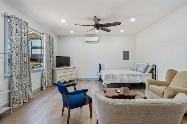 bedroom with electric panel, baseboards, light wood-type flooring, a wall mounted AC, and recessed lighting