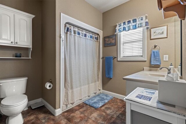 bathroom featuring vanity, toilet, and a shower with curtain