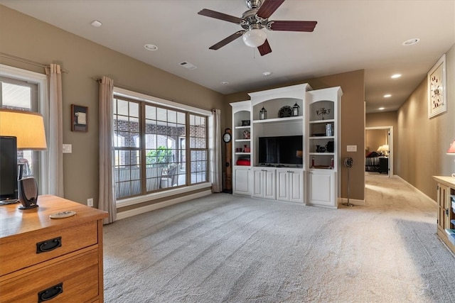 carpeted living room featuring ceiling fan