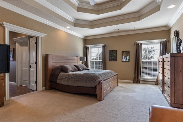 bedroom with carpet flooring, a raised ceiling, and ornamental molding